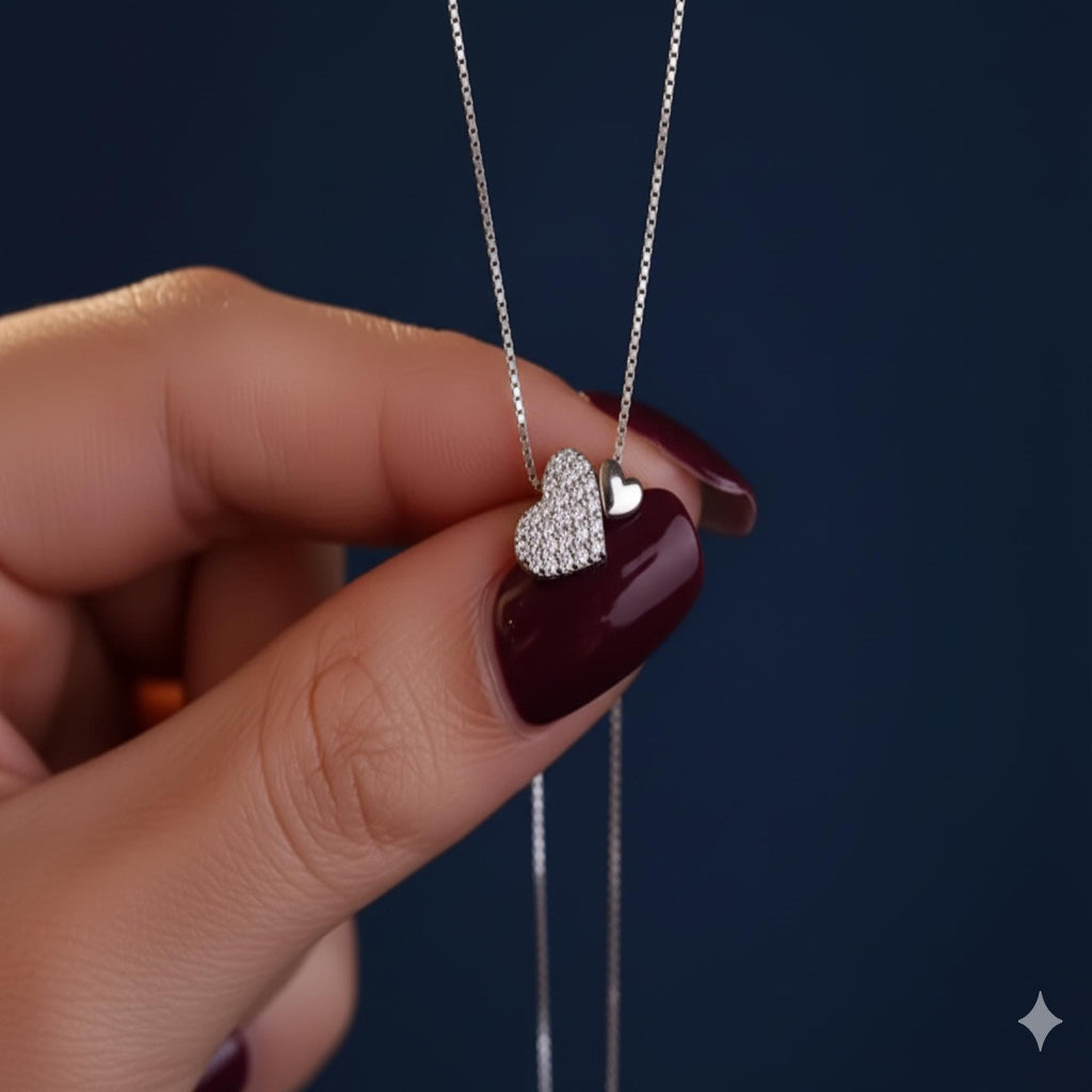 Sterling silver heart pendant necklace with zirconia accents on a delicate clavicle chain, designed by Luxe Treasures.