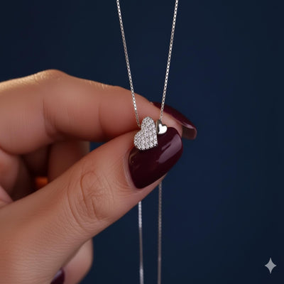 Sterling silver heart pendant necklace with zirconia accents on a delicate clavicle chain, designed by Luxe Treasures.