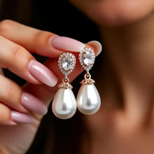 Load image into Gallery viewer, Luxe Treasures teardrop pearl dangle earrings with crystal halo accents, bridal jewelry with elegant, hanging pearl design.