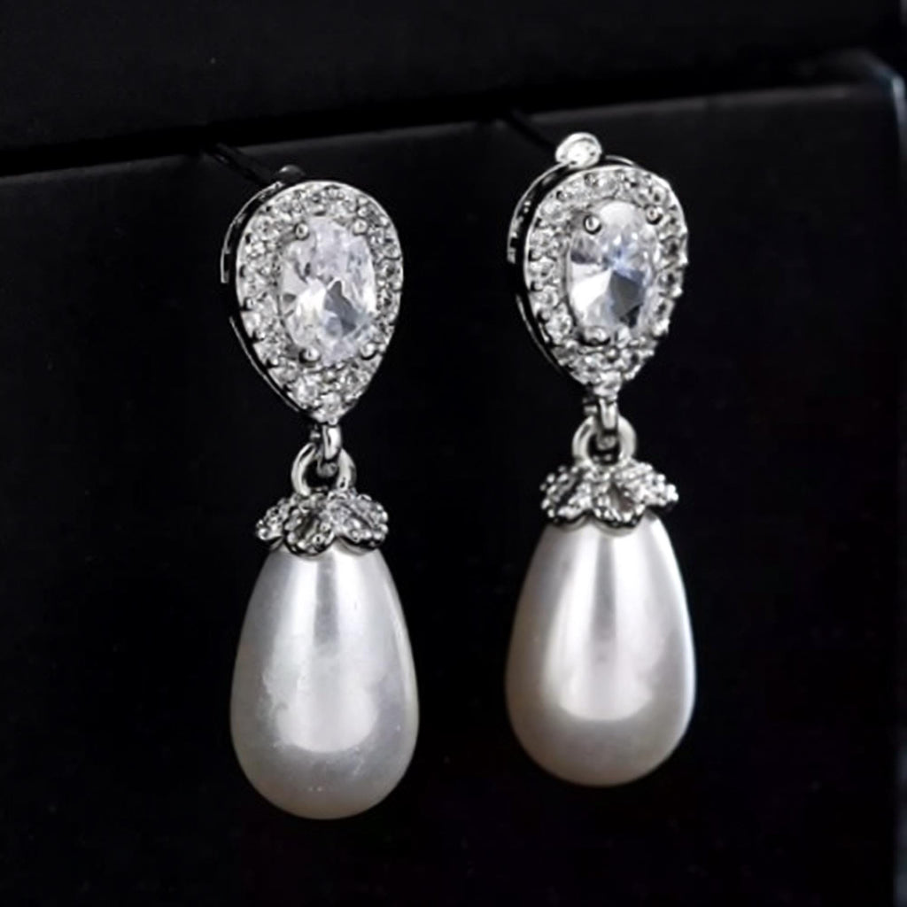 Luxe Treasures teardrop pearl dangle earrings with crystal halo accents, elegant bridal jewelry for special occasions.