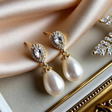 Load image into Gallery viewer, Luxe Treasures teardrop pearl dangle earrings with crystal halo design, perfect for bridal jewelry and special occasions.